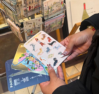 Picture of someone holding three postcards