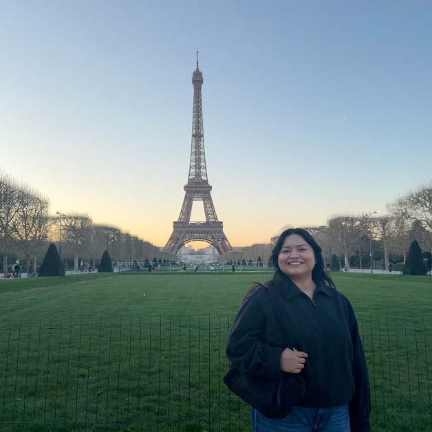 Picture of Emmily standing in front of the Eiffel Tower